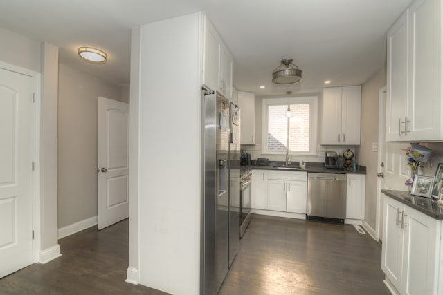 kitchen featuring sink, white cabinetry, dark wood-type flooring, and stainless steel appliances