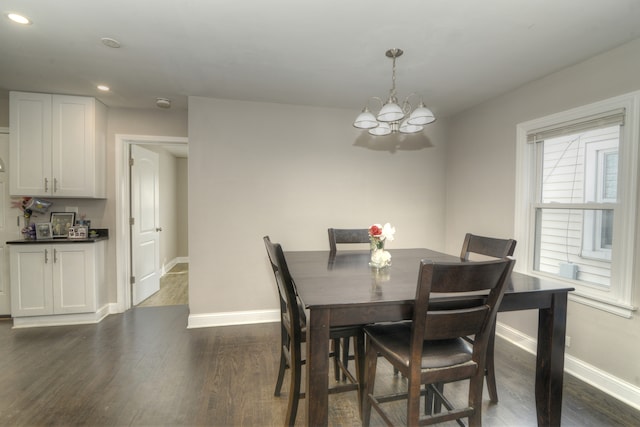 dining room with a chandelier and dark hardwood / wood-style floors