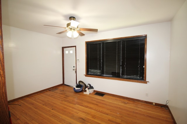 spare room with ceiling fan and wood-type flooring