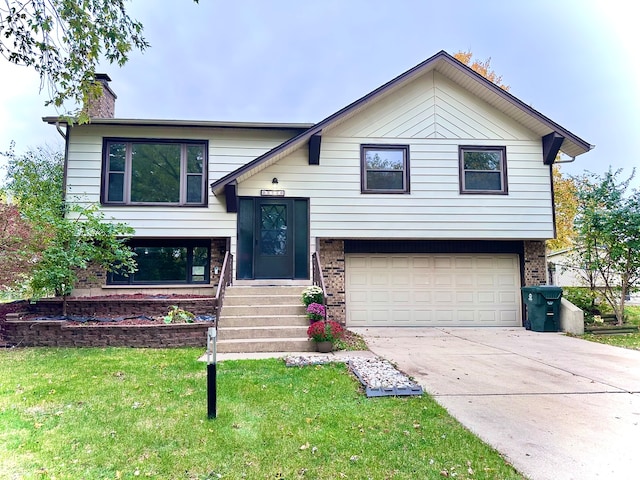 raised ranch with a front yard and a garage