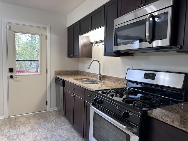 kitchen featuring stainless steel appliances, dark brown cabinetry, and sink