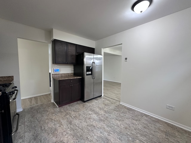 kitchen featuring black range with electric cooktop, stainless steel fridge with ice dispenser, dark brown cabinetry, and light hardwood / wood-style flooring