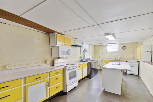 kitchen featuring washer / dryer, a center island with sink, and white appliances