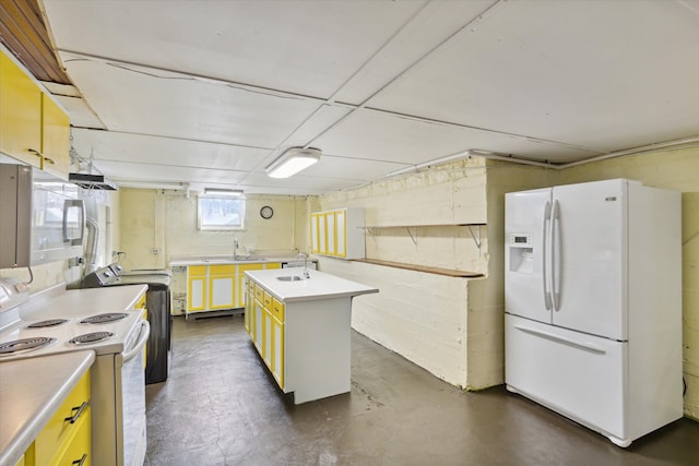 kitchen with an island with sink, sink, and white appliances