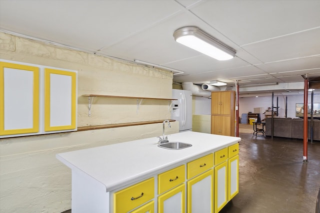 kitchen with white fridge with ice dispenser, sink, and a kitchen island