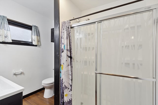 bathroom with vanity, a shower with shower curtain, hardwood / wood-style flooring, and toilet