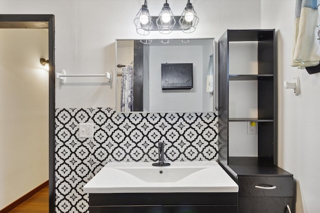 bathroom with vanity, decorative backsplash, and hardwood / wood-style floors