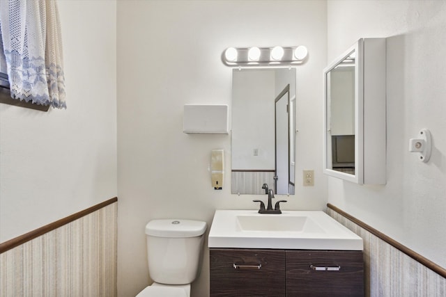 bathroom featuring toilet and vanity