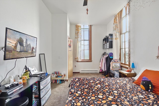 carpeted bedroom featuring ceiling fan and a baseboard radiator