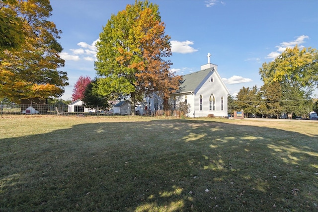 view of side of property with a yard