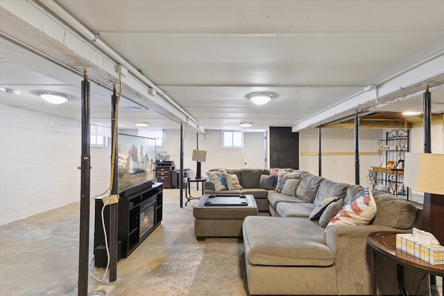 living room with concrete flooring and a fireplace