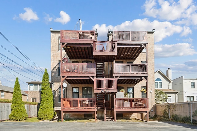 rear view of property featuring a balcony