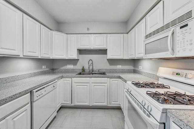 kitchen with white appliances, light tile patterned flooring, white cabinetry, and sink