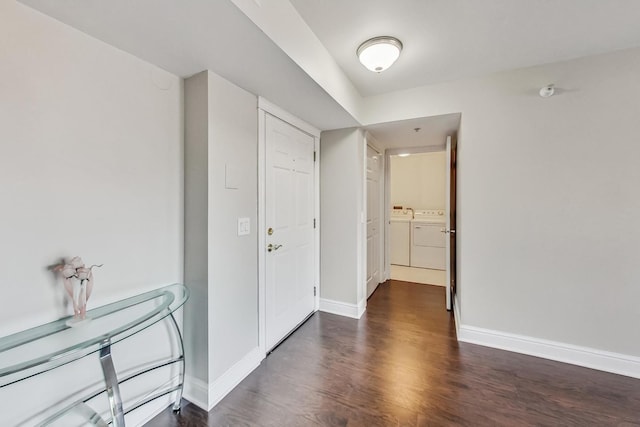 interior space with independent washer and dryer and dark hardwood / wood-style flooring