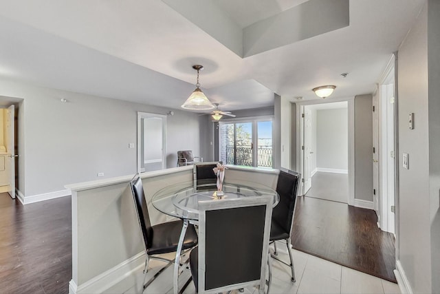 dining space featuring ceiling fan, washer / clothes dryer, and hardwood / wood-style floors