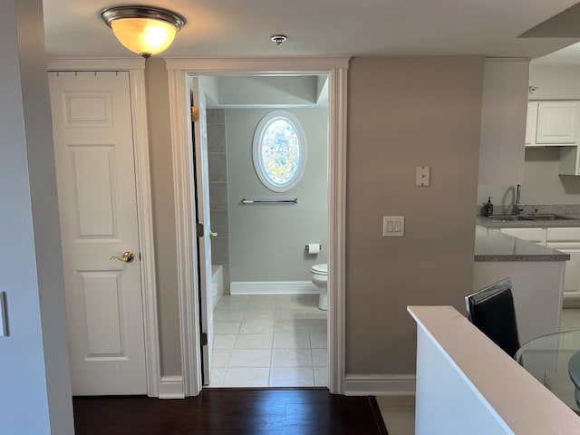 corridor featuring light hardwood / wood-style floors and sink