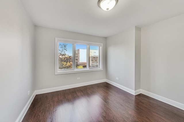 empty room featuring dark wood-type flooring