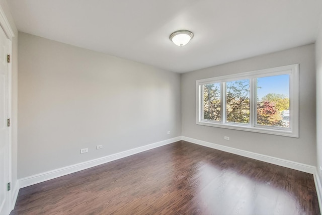 unfurnished room with dark hardwood / wood-style floors