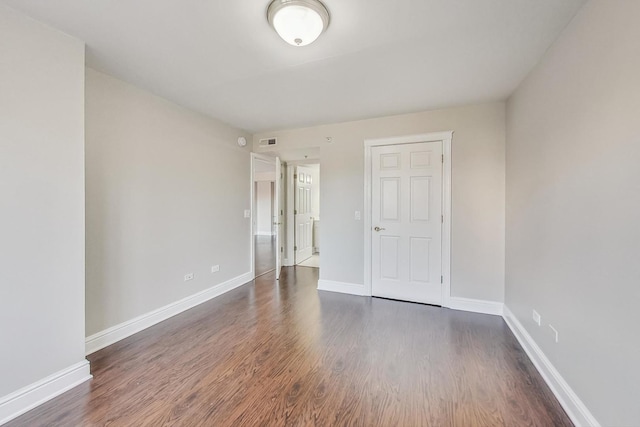 spare room featuring dark hardwood / wood-style floors