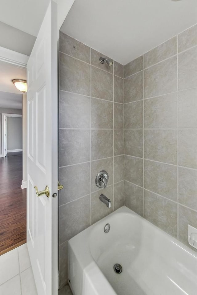 bathroom featuring hardwood / wood-style flooring and tiled shower / bath combo