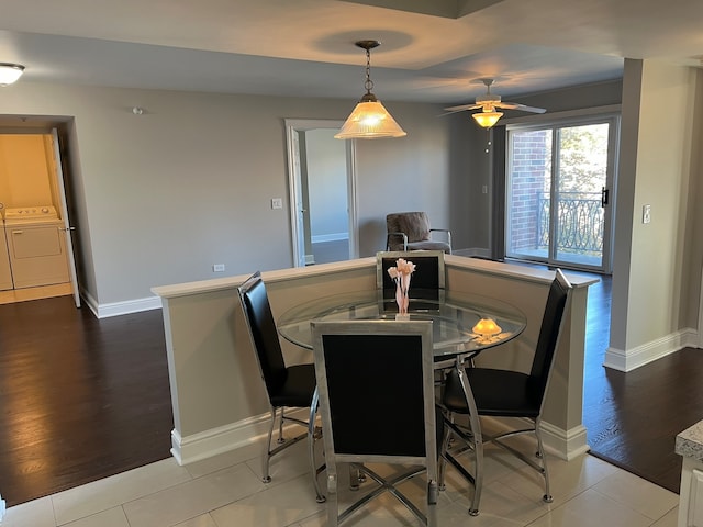 dining space featuring light hardwood / wood-style floors, washing machine and dryer, and ceiling fan