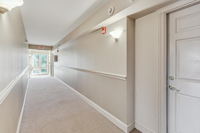 hallway featuring light carpet