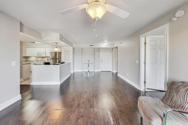 living room featuring dark hardwood / wood-style floors and ceiling fan