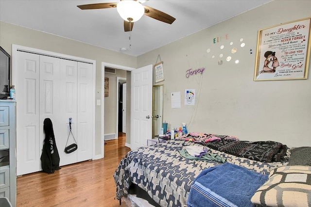 bedroom with wood-type flooring, a closet, and ceiling fan