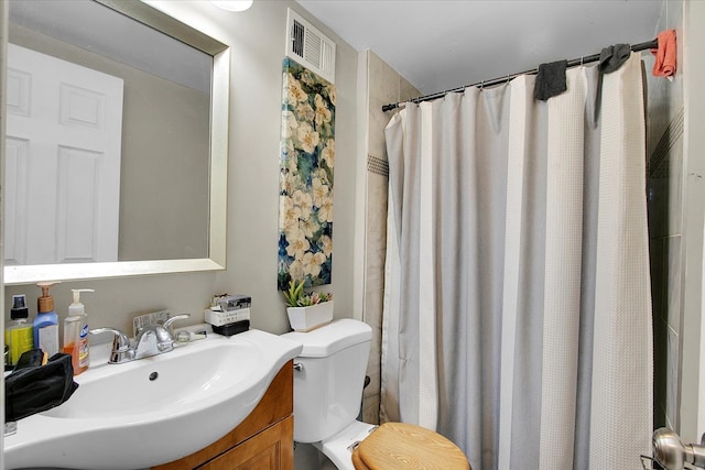 bathroom featuring toilet, a shower with curtain, and vanity