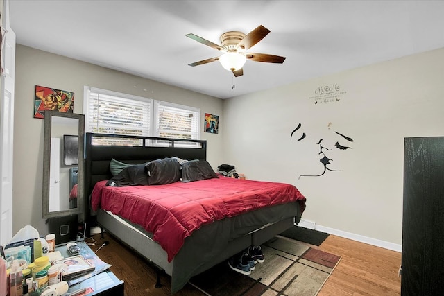 bedroom with ceiling fan and hardwood / wood-style flooring