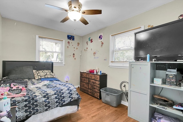 bedroom with light wood-type flooring and ceiling fan