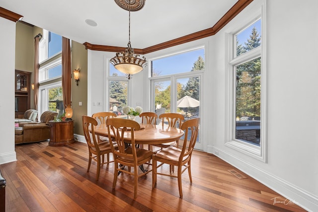 dining room featuring hardwood / wood-style flooring and ornamental molding