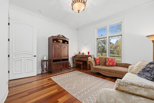 living room featuring hardwood / wood-style flooring and ornamental molding