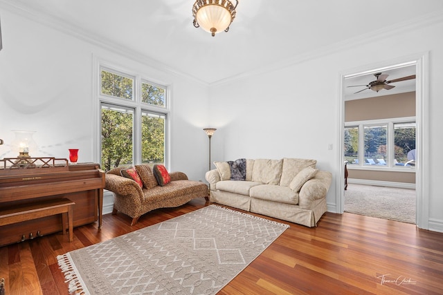 living room with crown molding, plenty of natural light, and hardwood / wood-style flooring