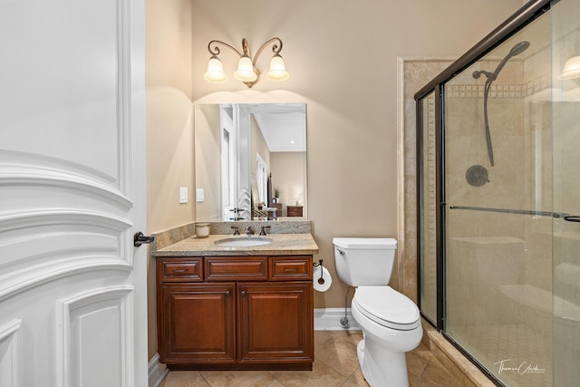 bathroom with walk in shower, tile patterned floors, vanity, and toilet