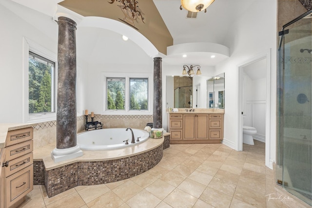 full bathroom featuring vanity, plus walk in shower, vaulted ceiling, toilet, and ornate columns