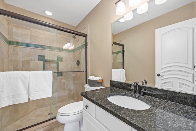 bathroom with toilet, vanity, tile patterned floors, and walk in shower