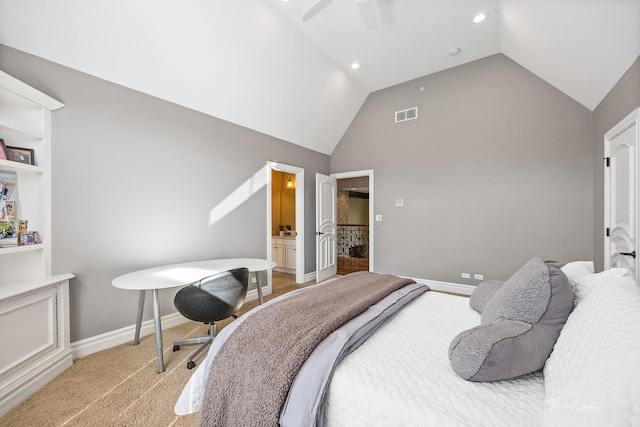 carpeted bedroom with ceiling fan, lofted ceiling, and ensuite bath