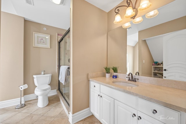 bathroom featuring vanity, toilet, a shower with shower door, and tile patterned flooring