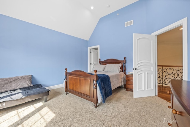 bedroom featuring light carpet and high vaulted ceiling