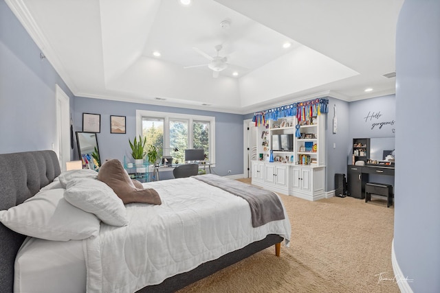 carpeted bedroom featuring ornamental molding, ceiling fan, and a tray ceiling