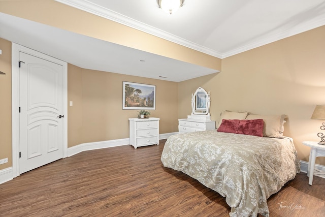 bedroom with ornamental molding and dark hardwood / wood-style floors