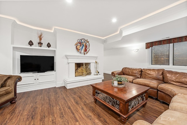 living room featuring dark hardwood / wood-style flooring and crown molding