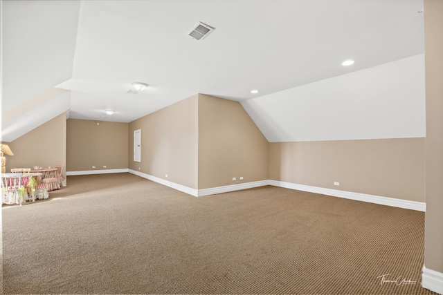 additional living space with lofted ceiling and carpet floors