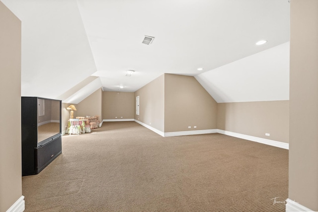 bonus room with lofted ceiling and carpet