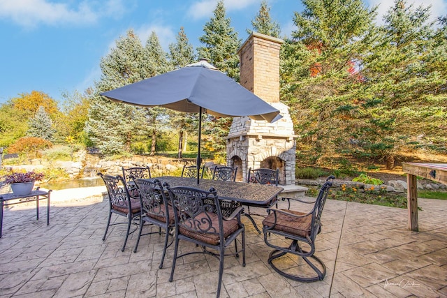 view of patio featuring an outdoor stone fireplace