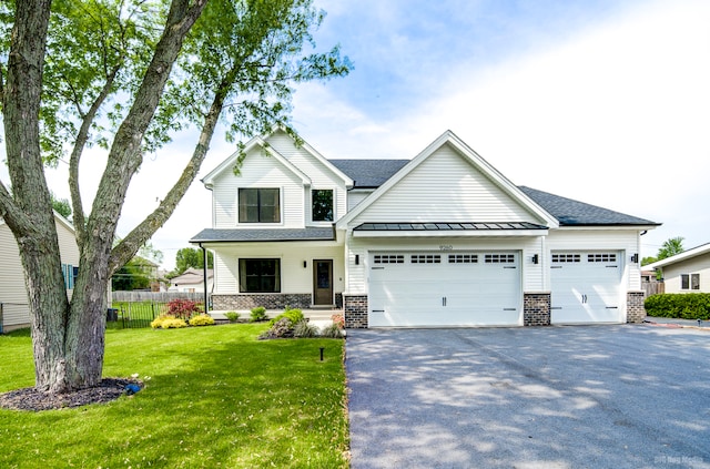 view of front of home featuring a front yard and a garage