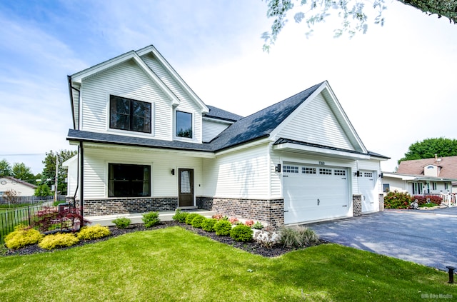 view of front of property featuring a front yard and a garage