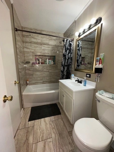 full bathroom featuring toilet, ornamental molding, shower / bath combo with shower curtain, and vanity