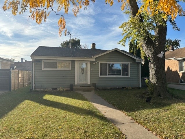 bungalow-style house featuring a front yard